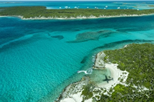 Aerial photo looking down at the airplanes shadow a jetski and clear tropical water Aerial photo looking down at the airplanes shadow a jetski and clear tropical water