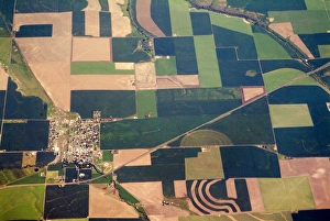 Aerial view of small town surrounded by patchwork quilt of agricultural fields in Aerial view of small town surrounded by patchwork quilt of agricultural fields in