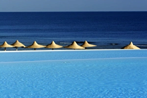 Africa, Egypt, Marsa Alam, Red Sea, beachside pool and umbrellas Africa, Egypt, Marsa Alam, Red Sea, beachside pool and umbrellas