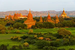 Ancient temple and pagoda rising out of the jungle at sunrise, Bagan, Mandalay Region Ancient temple and pagoda rising out of the jungle at sunrise, Bagan, Mandalay Region