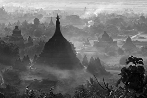 Ancient temples and pagodas in the jungle rising above sunset mist, Mrauk-U, Rakhine State Ancient temples and pagodas in the jungle rising above sunset mist, Mrauk-U, Rakhine State