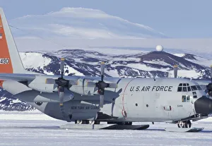 Antarctica, Ross Island, McMurdo station, C-130 Hercules on ice runway, Mt. Erebus beyond Antarctica, Ross Island, McMurdo station, C-130 Hercules on ice runway, Mt. Erebus beyond