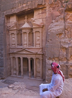 Arab man watching Facade of Treasury (Al Khazneh), Petra, Jordan (UNESCO World Heritage Arab man watching Facade of Treasury (Al Khazneh), Petra, Jordan (UNESCO World Heritage