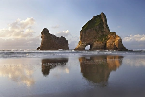 Archway Islands Reflected in Wet Sands of Wharariki Beach, near Cape Farewell, North Archway Islands Reflected in Wet Sands of Wharariki Beach, near Cape Farewell, North