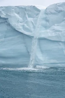 Arctic, Svalbard, Nordaustlandet Island. Waterfalls cascading from the melting glacier Arctic, Svalbard, Nordaustlandet Island. Waterfalls cascading from the melting glacier