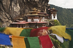 Asia, Bhutan. Prayer flags flap near Taktshang or Tigers Nest, the most famous monastery in Bhutan Asia, Bhutan. Prayer flags flap near Taktshang or Tigers Nest, the most famous monastery in Bhutan