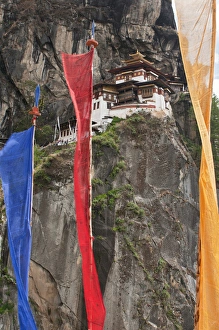 Asia, Bhutan. Prayer flags hang near Taktshang or Tigers Nest, the most famous monastery in Bhutan Asia, Bhutan. Prayer flags hang near Taktshang or Tigers Nest, the most famous monastery in Bhutan