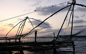 Asia, India, Kerala, Kochi (Cochin). A silhouette of a Chinese fishing net Asia, India, Kerala, Kochi (Cochin). A silhouette of a Chinese fishing net