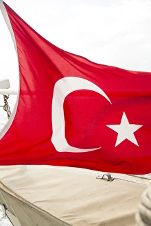 Asia, Turkey. The flag of Turkey is a red flag featuring a white crescent and a white star Asia, Turkey. The flag of Turkey is a red flag featuring a white crescent and a white star