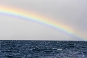 Australia, Tasmania, Maria Island. Rainbow in Tasman Sea Australia, Tasmania, Maria Island. Rainbow in Tasman Sea