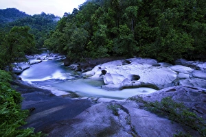 The Babinda Boulders is a fast-flowing river surrounded by smooth boulders and a The Babinda Boulders is a fast-flowing river surrounded by smooth boulders and a