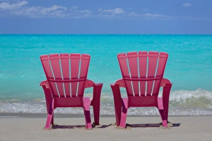 Bahamas, Little Exuma Island. Pink chairs on beach Bahamas, Little Exuma Island. Pink chairs on beach
