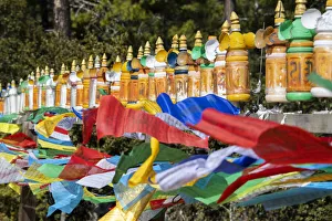 Bhutan, Paro. Colorful prayer wheels and flags along the hiking trail to the Tiger' Bhutan, Paro. Colorful prayer wheels and flags along the hiking trail to the Tiger'