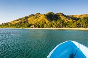 Blue boat cruising through the Yasawas, Fiji, South Pacific Blue boat cruising through the Yasawas, Fiji, South Pacific