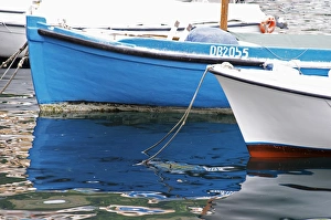 a blue and a white boat in the old Marina harbour Dubrovnik, old city. Dalmatian Coast a blue and a white boat in the old Marina harbour Dubrovnik, old city. Dalmatian Coast
