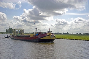 Boat traveling on a canal east of Leiden in the province of South Holland, Netherlands Boat traveling on a canal east of Leiden in the province of South Holland, Netherlands
