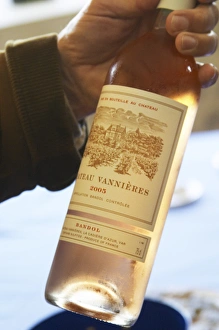Bottle of rose wine 2005 in a hand Chateau Vannieres (Vannieres) La Cadiere (Cadiere) Bottle of rose wine 2005 in a hand Chateau Vannieres (Vannieres) La Cadiere (Cadiere)
