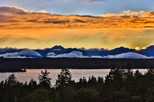Bremerton, Washington. The Olympic Mountains, featuring Brothers Mountain, bask in a golden Bremerton, Washington. The Olympic Mountains, featuring Brothers Mountain, bask in a golden