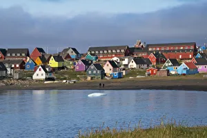 Brightly painted houses on the beach, Qeqertarsuaq, Greenland Brightly painted houses on the beach, Qeqertarsuaq, Greenland