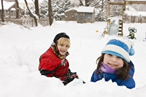 A brother and sister play in a snow fort in their backyard in Portsmouth, New Hampshire A brother and sister play in a snow fort in their backyard in Portsmouth, New Hampshire