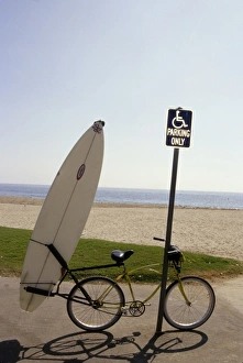 California: Santa Barbara, Leadbetter beach, bike and surfboard resting against sign post California: Santa Barbara, Leadbetter beach, bike and surfboard resting against sign post