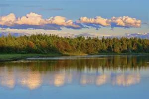 Canada, New Brunswick, Richibucto. Clouds reflected in an inlet at sunset. Credit as Canada, New Brunswick, Richibucto. Clouds reflected in an inlet at sunset. Credit as