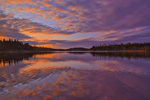 Canada, Ontario, Kenora District. Forest autumn colors reflect on Middle Lake at sunrise Canada, Ontario, Kenora District. Forest autumn colors reflect on Middle Lake at sunrise