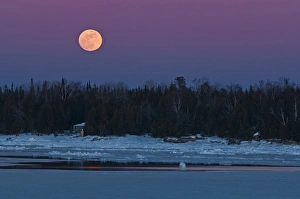 Canada, Ontario, South Baymouth. Full moon rising over Lake Huron in winter. Credit as Canada, Ontario, South Baymouth. Full moon rising over Lake Huron in winter. Credit as