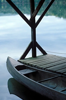 A canoe rests at the dock in first light of morning A canoe rests at the dock in first light of morning