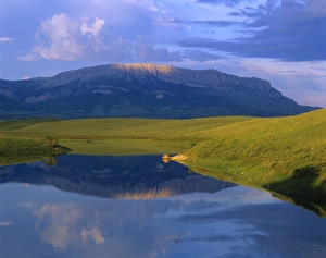 Castle Reef reflects into the Pishkun Canal along the Rocky Mountain Front in Montana Castle Reef reflects into the Pishkun Canal along the Rocky Mountain Front in Montana