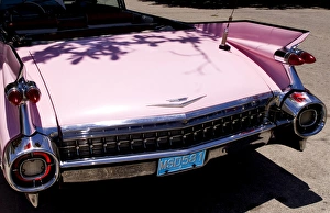 Classic 1959 pink Cadillac convertible on road in beautiful Varadero Beach in Valadero Classic 1959 pink Cadillac convertible on road in beautiful Varadero Beach in Valadero