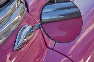 Close-up side mirror on hot pink classic American Oldsmobile in Vieja, old Habana, Havana Close-up side mirror on hot pink classic American Oldsmobile in Vieja, old Habana, Havana