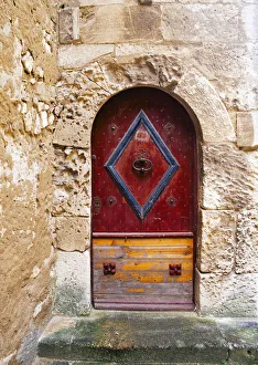 Colorful door in the stone wall of a chateau in France Colorful door in the stone wall of a chateau in France