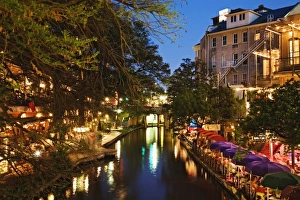 Colorful umbrellas of outdoor cafe at dusk along River Walk, San Antonio River Colorful umbrellas of outdoor cafe at dusk along River Walk, San Antonio River