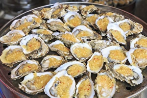 cooked oysters on a platter, shops around Nine Pedestrian Street, Guangzhou, China cooked oysters on a platter, shops around Nine Pedestrian Street, Guangzhou, China