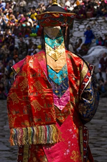 Costumed dancers at religious festivity with many visitors, Paro Tsechu, Bhutan Costumed dancers at religious festivity with many visitors, Paro Tsechu, Bhutan