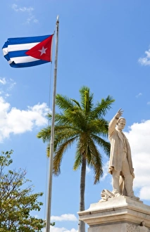 Cuban flag and statue in center of town of Jose Marti hero in CVienfuegos Cuba Cuban flag and statue in center of town of Jose Marti hero in CVienfuegos Cuba
