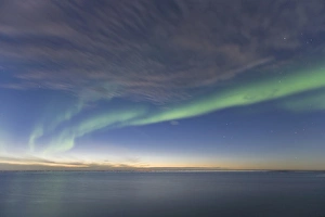 Curtains of green Aurora Borealis dance over the iceberg dotted surface of the Beaufort Curtains of green Aurora Borealis dance over the iceberg dotted surface of the Beaufort