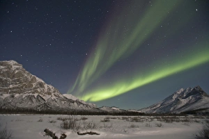 Curtains of green aurora borealis fill the sky over high peaks of the Central Brooks Curtains of green aurora borealis fill the sky over high peaks of the Central Brooks