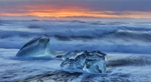 Diamond ice chards from calving icebergs on black sand beach at Jokulsarlon in south Diamond ice chards from calving icebergs on black sand beach at Jokulsarlon in south