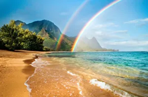 A double rainbow over the coastline of a Hawaiian island with mountains A double rainbow over the coastline of a Hawaiian island with mountains