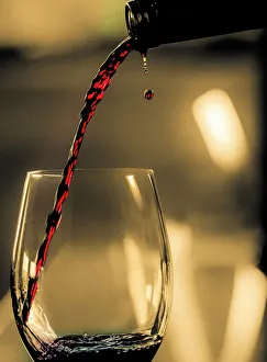 One drop shows as red wine is poured into glass