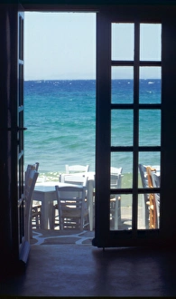 Europe, Greece, Cyclades, Island of Mykonos. View of ocean through restaurant door Europe, Greece, Cyclades, Island of Mykonos. View of ocean through restaurant door