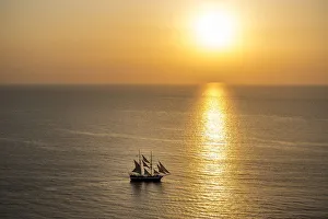 Europe, Greece, Santorini, Cyclades. Sailboat on ocean at sunset Europe, Greece, Santorini, Cyclades. Sailboat on ocean at sunset
