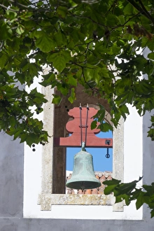 Europe, Portugal, Obidos. Patina-aged, oxidized copper church bell Europe, Portugal, Obidos. Patina-aged, oxidized copper church bell