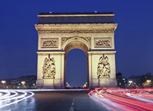 Evening traffic around the Arc de Triomphe, Paris, France Evening traffic around the Arc de Triomphe, Paris, France