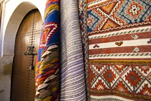 Fez Morocco decorative door and hanging patterned carpets in the old medina Fez Morocco decorative door and hanging patterned carpets in the old medina