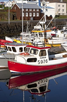Fishing boats mirrored in the waters of the inner harbor of Stykkisholmur, Iceland Fishing boats mirrored in the waters of the inner harbor of Stykkisholmur, Iceland