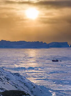 Fishing boats. Winter at the Ilulissat Fjord, located in the Disko Bay in West Greenland Fishing boats. Winter at the Ilulissat Fjord, located in the Disko Bay in West Greenland