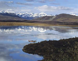 Cloudy Mountain Range Scenery Prints: Float Plane on Lake, Denali Highway, Alaska Mountain range in background, Alaska